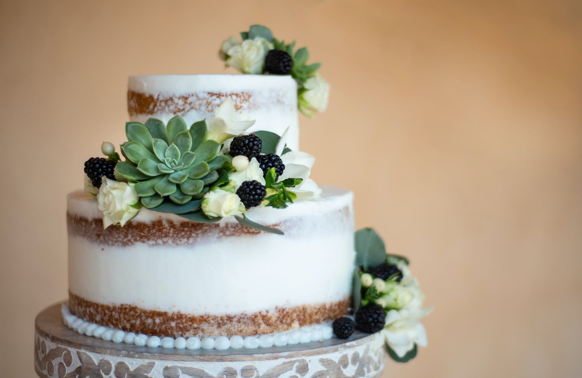 Layered cake with blackberry and rose decoration