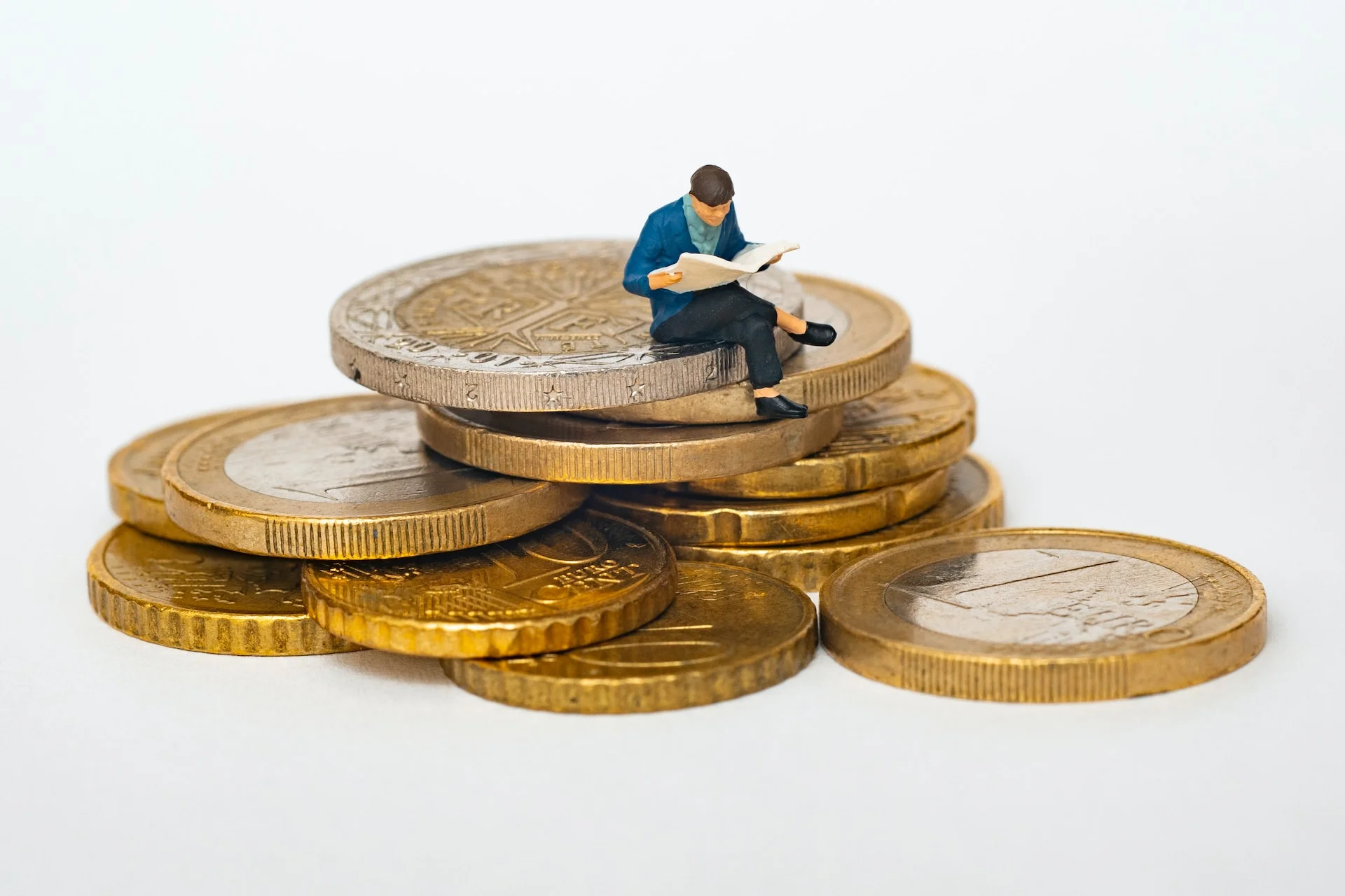Figurine of a man sitting on coins