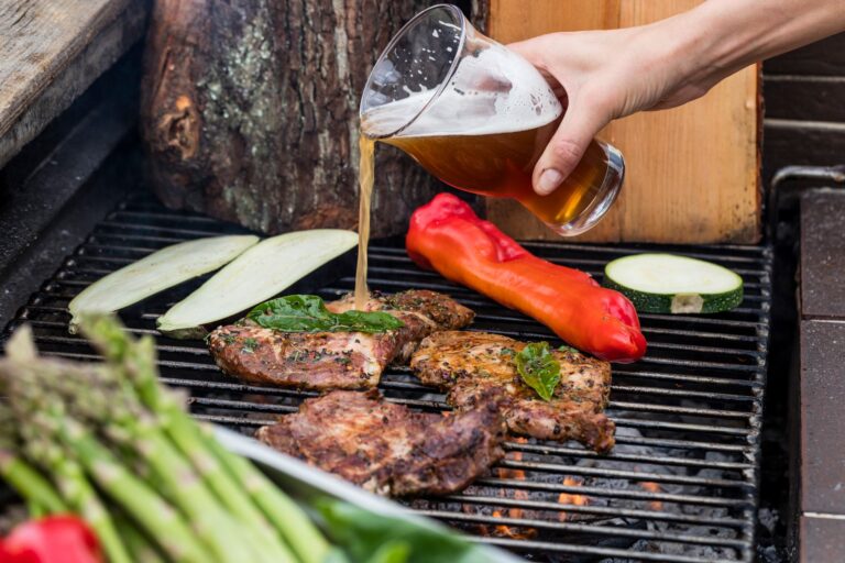 pouring beer on pork neck at a company event - barbecue at Dwór Korona Karkonoszy