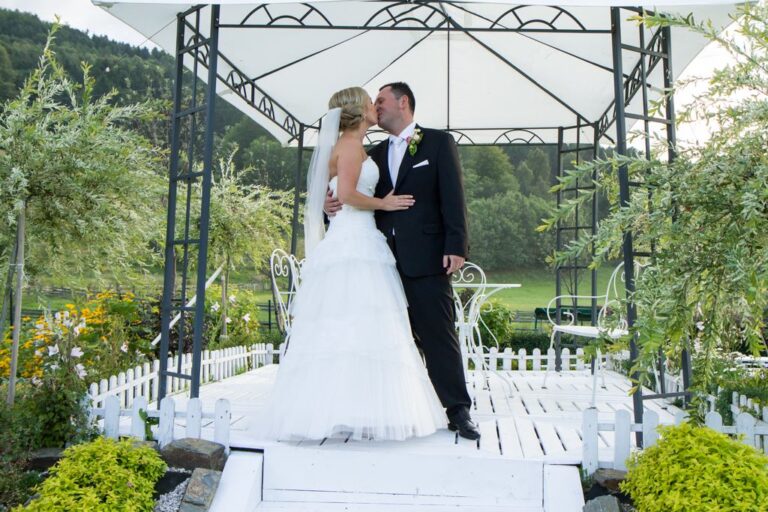 young couple kissing, wedding in the garden, Crown Court of the Karkonosze Sosnówka near Karpacz